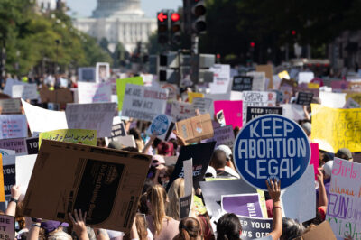 With the U.S Capitol in the back ground thousands of demonstrators march on Pennsylvania Avenue during the Women's March in Washington, Saturday, Oct. 2, 2021.