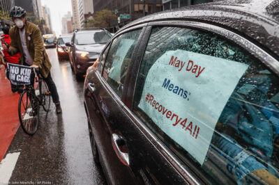 A caravan of May Day protestors drive up 2nd Avenue in New York City during COVID pandemic.