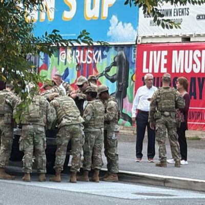 A group of National Guard troops speaking to DC civilians.