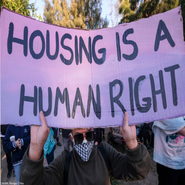 Activists and people experiencing homelessness gather near tents housing the homeless at an encampment in Echo Lake Park as the city makes plans to evict all the parks encampments in Los Angeles, March 24, 2021.