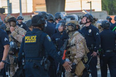 Border Patrol agents and police congregating during during a demonstration against expanded ICE operations and in support of immigrant rights.
