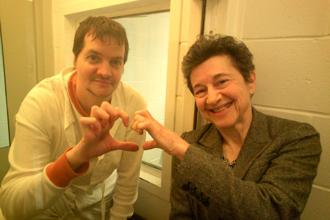 Richard Tabler and Claudia Van Wyk share a happy moment by making hearts with their fingers as they face the camera.